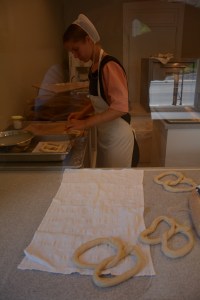 Making the pretzels: a young Amish woman